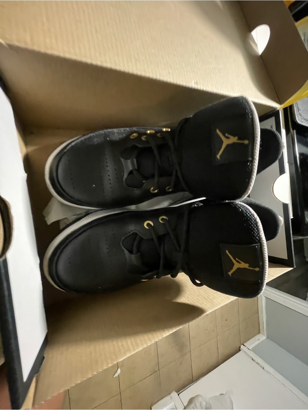 Jordan Black Sneakers with Gold Jumpman Accents